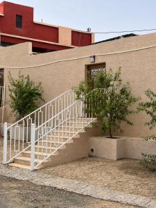 a white staircase on the side of a building at البساتين هومز - Al Basateen Homes in Al Baha