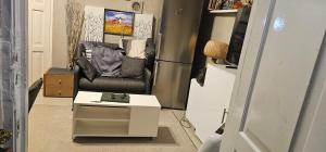 a living room with a chair and a coffee table at Victoria complex in Willemstad