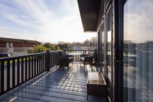 a balcony with benches and a view of the water at Penny Lodge with Hot Tub in Malton