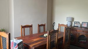 a wooden dining room table with chairs and a desk at stone cottage in Fir Tree