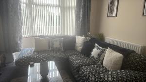 a living room with a couch and a window at stone cottage in Fir Tree +2 photos