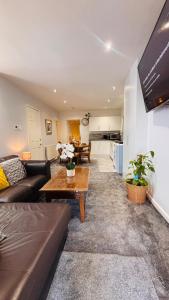 a living room with a couch and a table at Sleeps 5 Free Parking Fast WiFi Near Hillsborough Easy Access to Sheffield City Centre and Peak District in Hillsborough