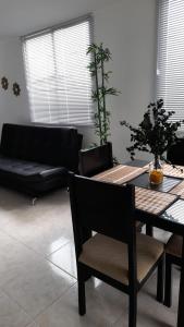 a living room with a table and a couch at Aptos hermosos en sector turistico in Montenegro