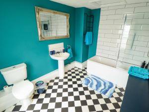 a bathroom with a white toilet and a sink at 35 Wrawby Street in Brigg +26 photos