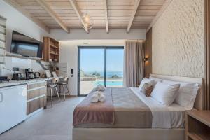 a bedroom with a large bed with a view of the ocean at Rodia Luxury Villa in Plakias +46 photos