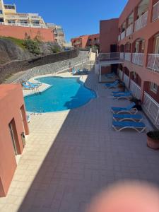 a resort with a swimming pool and lounge chairs at Il Paradiso Esiste in Costa Calma