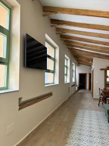 a living room with a flat screen tv on the wall at El gallinero de Valoria in Valoria la Buena