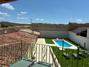 a view from the balcony of a house with a swimming pool at El gallinero de Valoria in Valoria la Buena