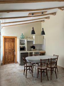 a kitchen with a table and chairs in a room at El gallinero de Valoria in Valoria la Buena
