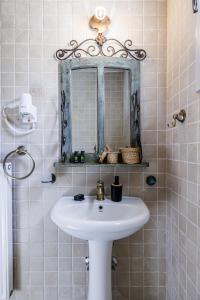 a bathroom with a sink and a mirror at Villa Calma in Patitiri +23 photos