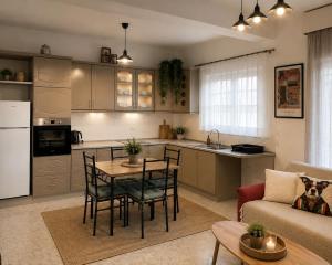a kitchen and living room with a table and chairs at Stavros Green & Sea Holiday Home in Stavros