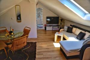 a living room with a couch and a table at Holiday Home Rocca with pool in Vrgorac
