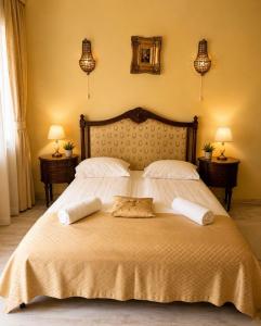 a bedroom with a large bed with two pillows on it at Pensiunea Cardinal in Sibiu