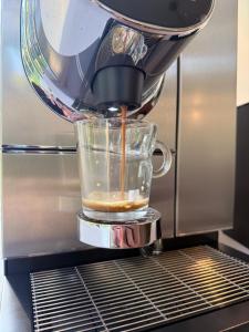 a mixer is making a drink in a glass container at Kronovall Park Residence in Skåne-Tranås +31 photos