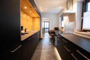 a large kitchen with black cabinets and a sink at Ferienwohnung Daniel in Garmisch-Partenkirchen