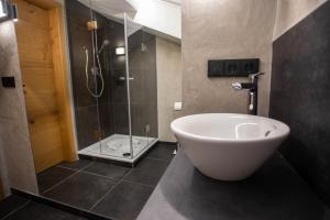 a bathroom with a shower and a white bath tub at Ferienwohnung Daniel in Garmisch-Partenkirchen +16 photos