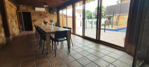 a dining room with a table and chairs and a patio at Casa Rural Arroyo 5 in Mejorada