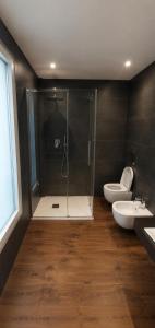 a bathroom with two toilets and a shower and a sink at Appartamento Doglio Lux in Cagliari +4 photos