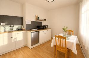 a kitchen with a table and a kitchen with a table and chairs at Gästehaus Kremser in Weiten