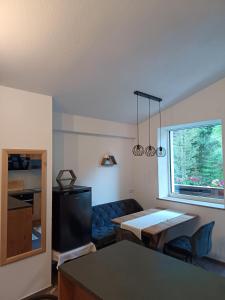 a living room with a blue couch and a table at Haus Bergfrieden in Kaunertal