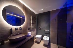 a bathroom with a sink and a tub and a toilet at Sant'Angela Rooms in Foligno +50 photos