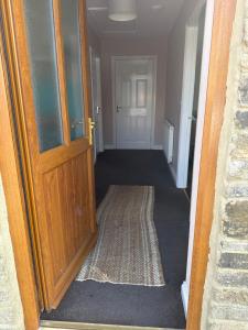 an open door to a hallway with a rug at Thornley pit house farm in Durham