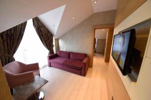 a living room with a couch and a tv at Le Mirage Hotel in Istanbul