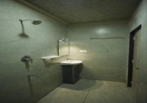 a bathroom with a sink and a shower at DEVATA SUITES in Vijayawāda