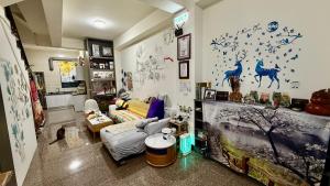 a living room with a couch and a living room witharijavascript at 潔希民宿一館 in Hsin-chieh
