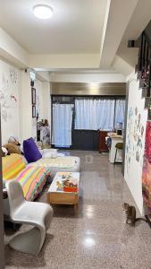 a bedroom with two beds and a cat sitting on the floor at 潔希民宿一館 in Hsin-chieh