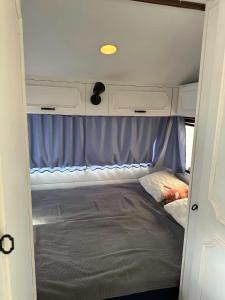 an interior of an rv with a bed in it at Przyczepa Kite Jastarnia blisko Zatoki Loop it in Jastarnia
