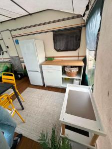 an interior view of an rv with a table and refrigerator at Przyczepa Kite Jastarnia blisko Zatoki Loop it in Jastarnia