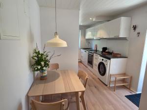 a kitchen and dining room with a table and a microwave at Lyckebo in Tyresö