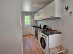 a kitchen with a washer and dryer in it at Lyckebo in Tyresö +8 photos