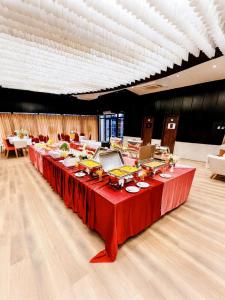 a long table in a room with red table cloth at Grand Mostafa Hotel in Sylhet