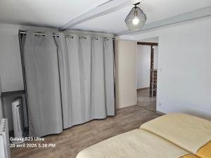 a bedroom with gray curtains and a bed at La Longère de Vin'Ay in Vinay +60 photos