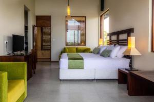 a bedroom with a bed and a couch and a television at Rock Wild Yala in Yala