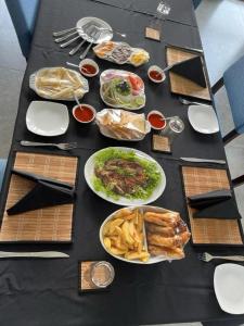 a black table with plates of food on it at Rock Wild Yala in Yala