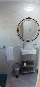 a bathroom with a sink and a mirror at Reef View BnB in East London