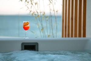 a glass of wine sitting in a bath tub at enplomare in Plomari