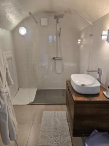 a white bathroom with a shower and a sink at La Tour Noble in Saint-Saturnin +58 photos