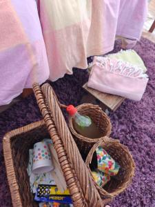 a group of baskets sitting on a rug with towels at Torpakka glamping in Mikkeli
