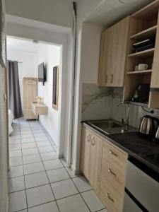 a kitchen with a sink and a counter top at Olimpus Sunset Studio in Paralia Katerinis