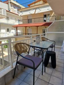 a balcony with a table and chairs on a balcony at Olimpus Sunset Studio in Paralia Katerinis