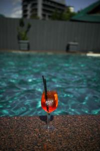 a drink in a glass next to a swimming pool at Imperial Hotel in Bukovel