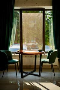 a table and two chairs in front of a window at Imperial Hotel in Bukovel