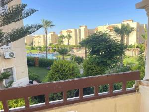 a view of a resort with palm trees and buildings at شاليه مارسليا بيتش in Dawwār Muḩammad Abū Shanab