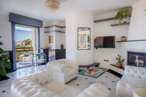 a living room with white furniture and a fireplace at Maison Panorama - Portofino View in Lavagna +34 photos
