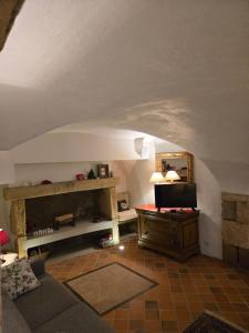 a living room with a couch and a desk at La Tour Noble in Saint-Saturnin
