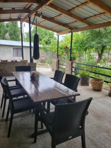 a wooden table and chairs on a patio at Tsinandali Wine cellar in Tsinandali